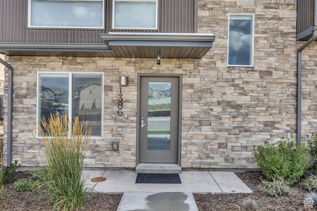 Doorway to property with stone siding