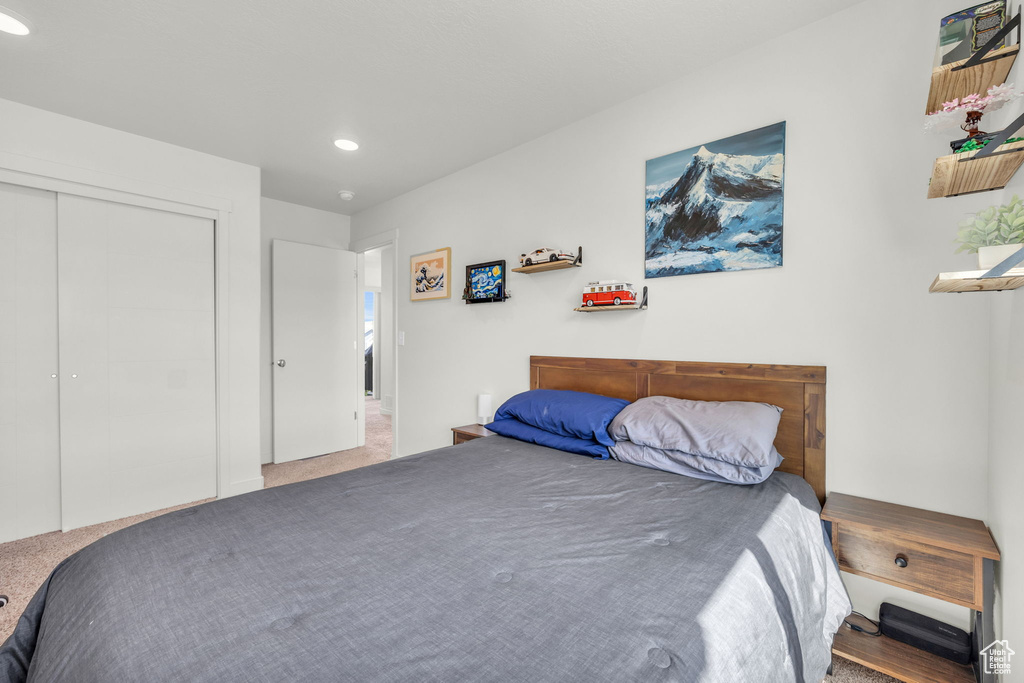 Bedroom with carpet floors, recessed lighting, and a closet