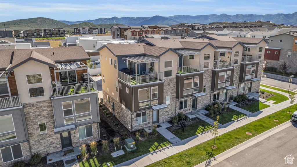 Aerial perspective of suburban area with a mountainous background