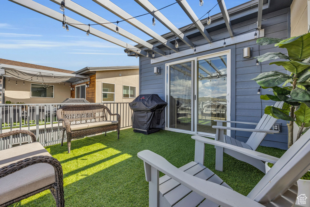 View of grassy yard with a pergola