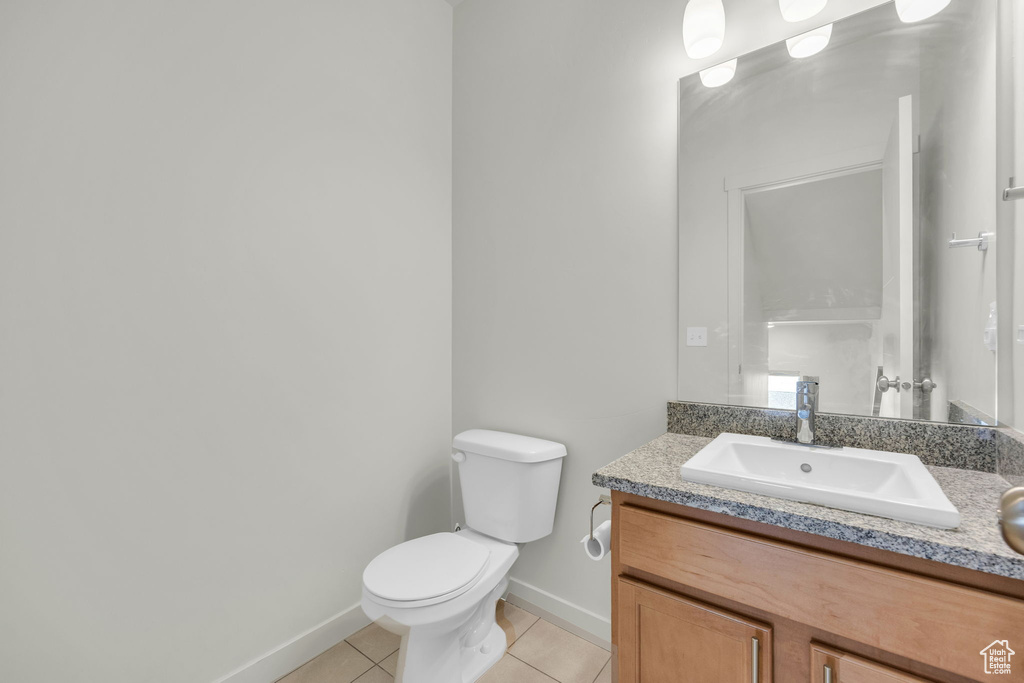 Bathroom with tile patterned floors and vanity