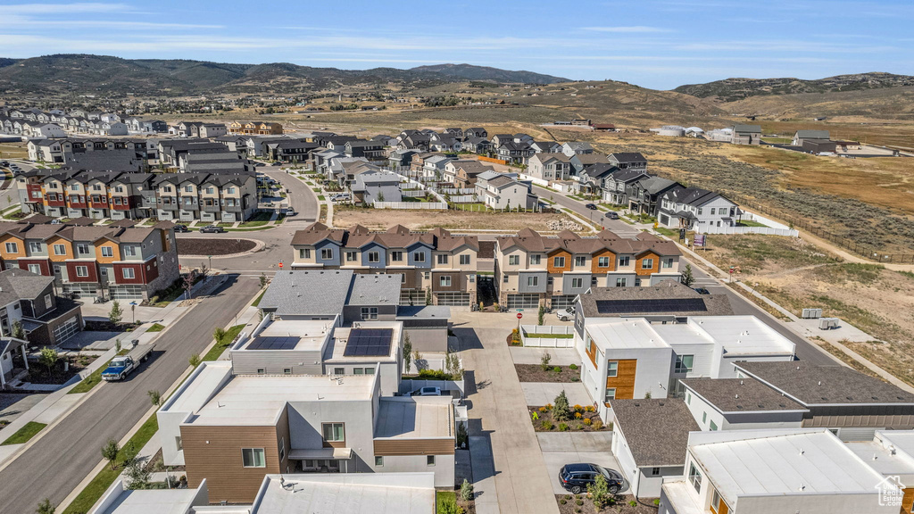 Aerial view of residential area featuring a mountainous background