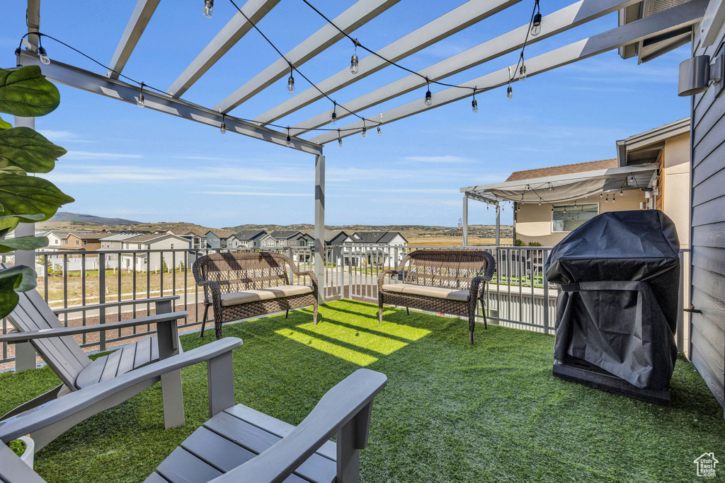 View of green lawn featuring a residential view and a pergola