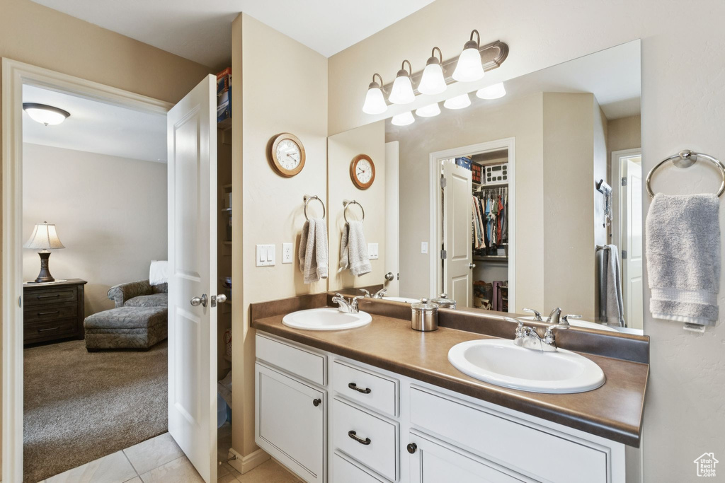 Full bath with ensuite bath, double vanity, and tile patterned flooring