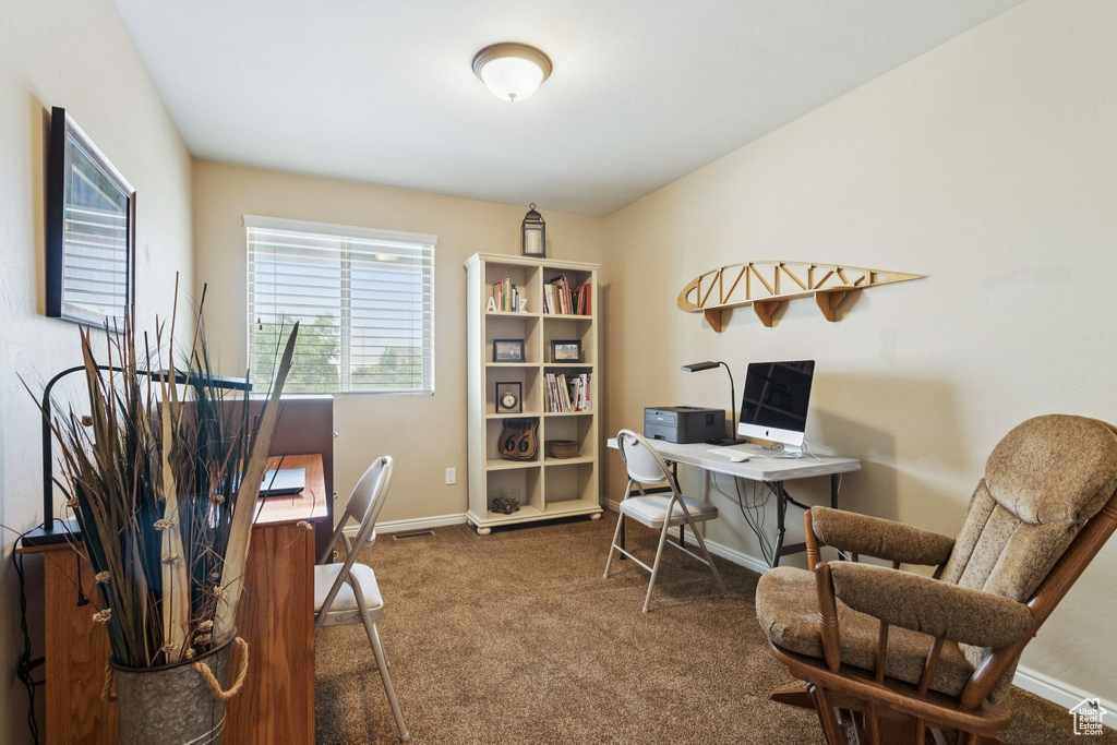 Home office with carpet flooring and baseboards