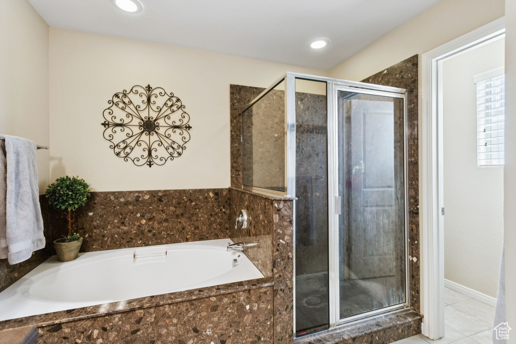 Bathroom with a shower stall, a bath, tile patterned floors, and recessed lighting