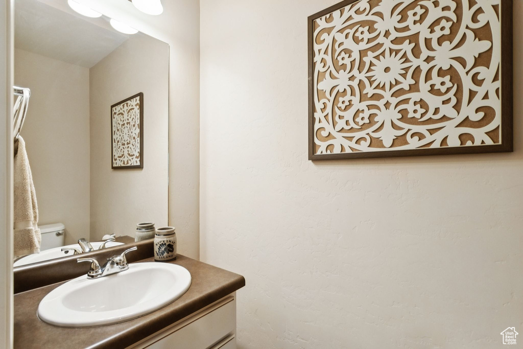 Half bath with vanity and toilet