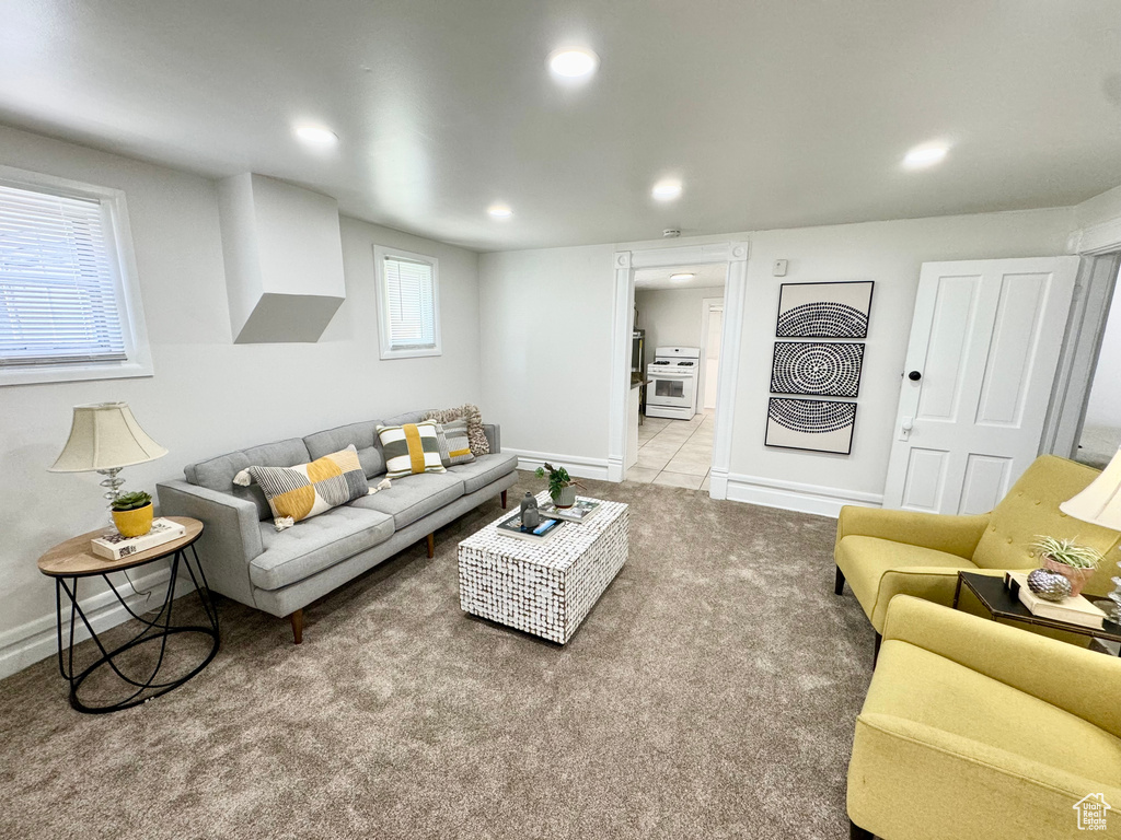 Carpeted living area with recessed lighting and baseboards