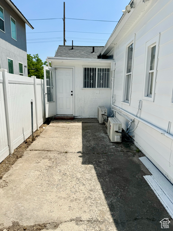 Property entrance featuring a shingled roof