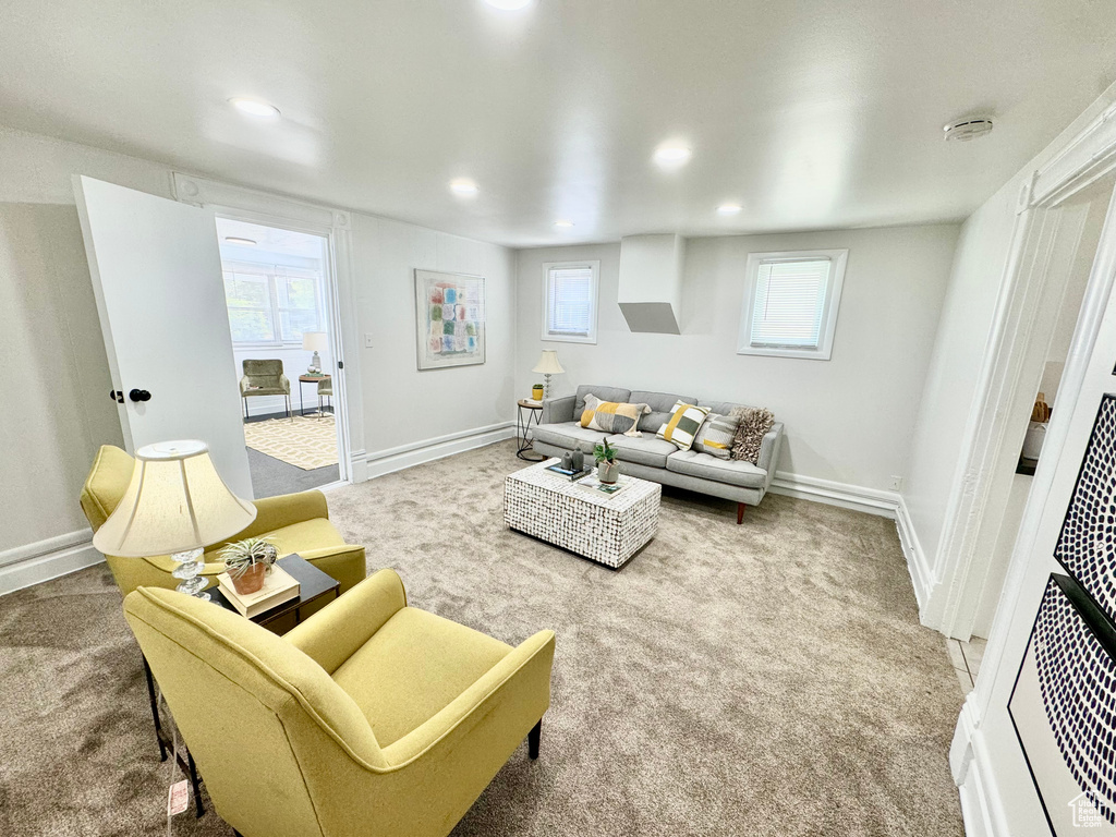 Living room with carpet floors, healthy amount of natural light, and recessed lighting