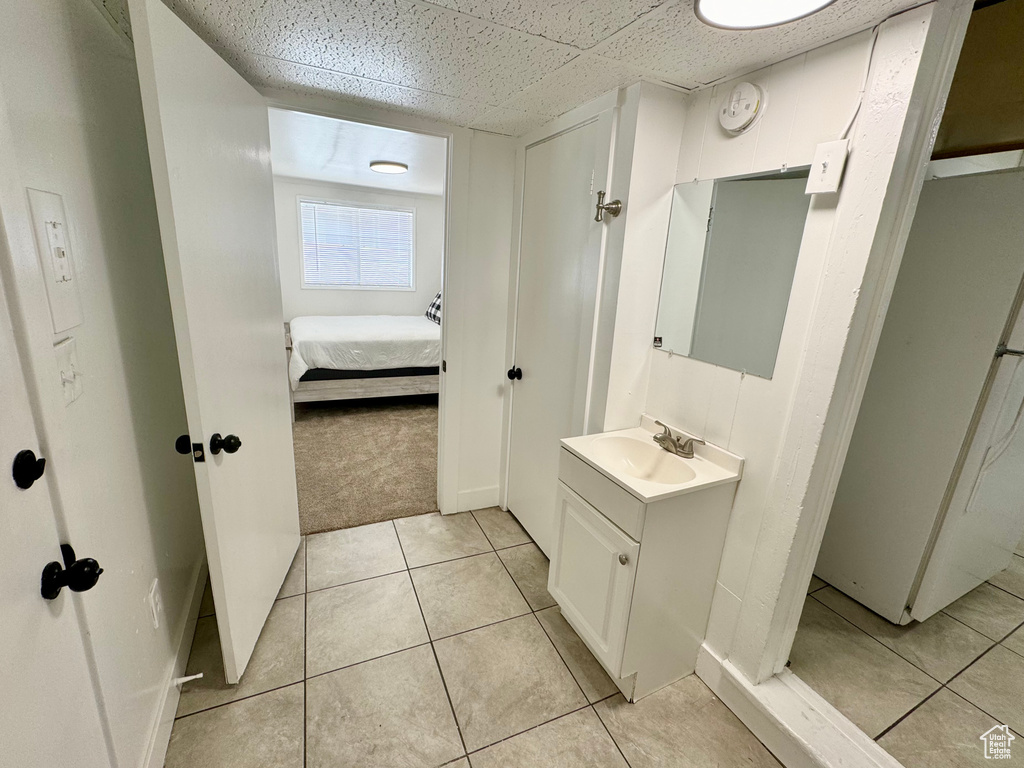Bathroom featuring vanity, ensuite bathroom, and tile patterned floors