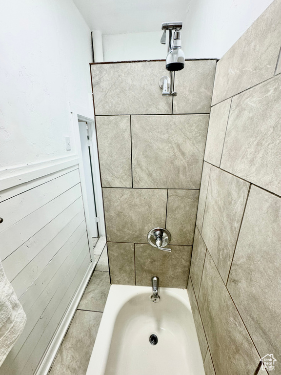 Full bath with a wainscoted wall