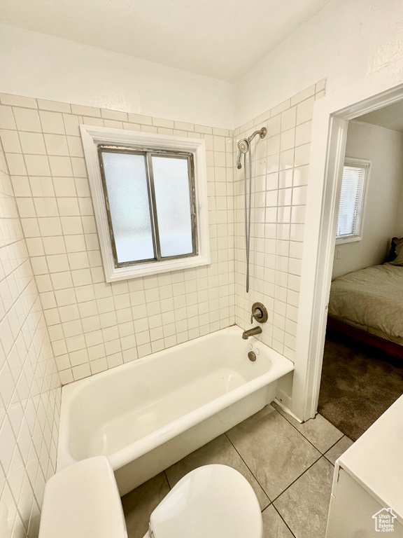 Ensuite bathroom featuring shower / washtub combination and tile patterned floors