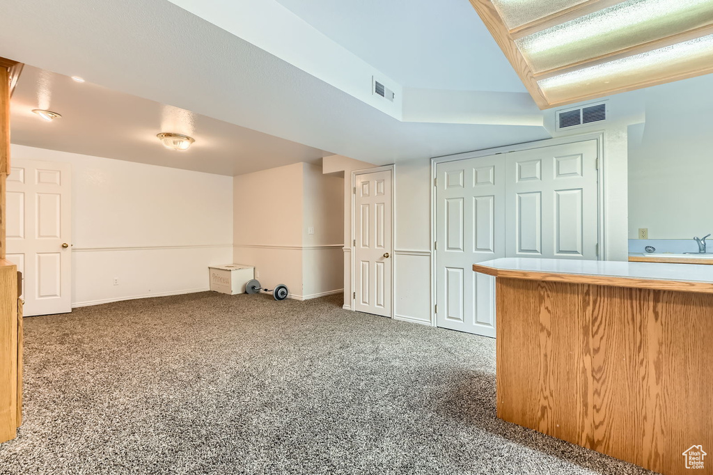Finished below grade area featuring carpet and baseboards