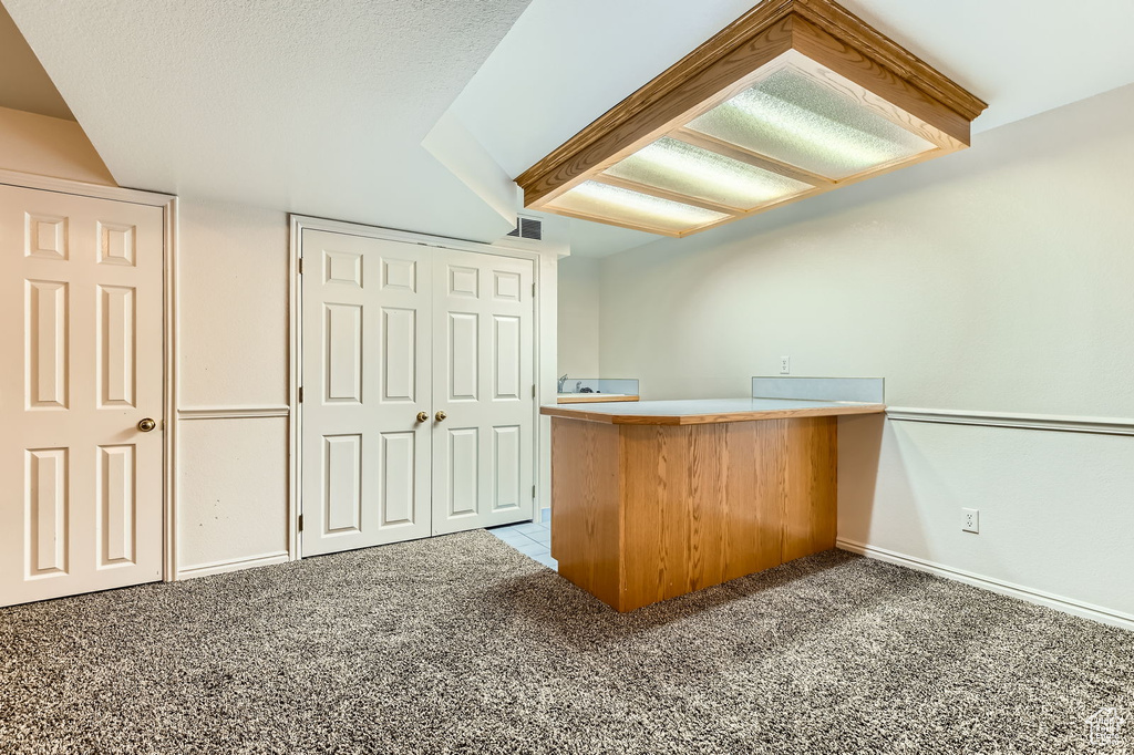 Bar area featuring carpet floors and baseboards