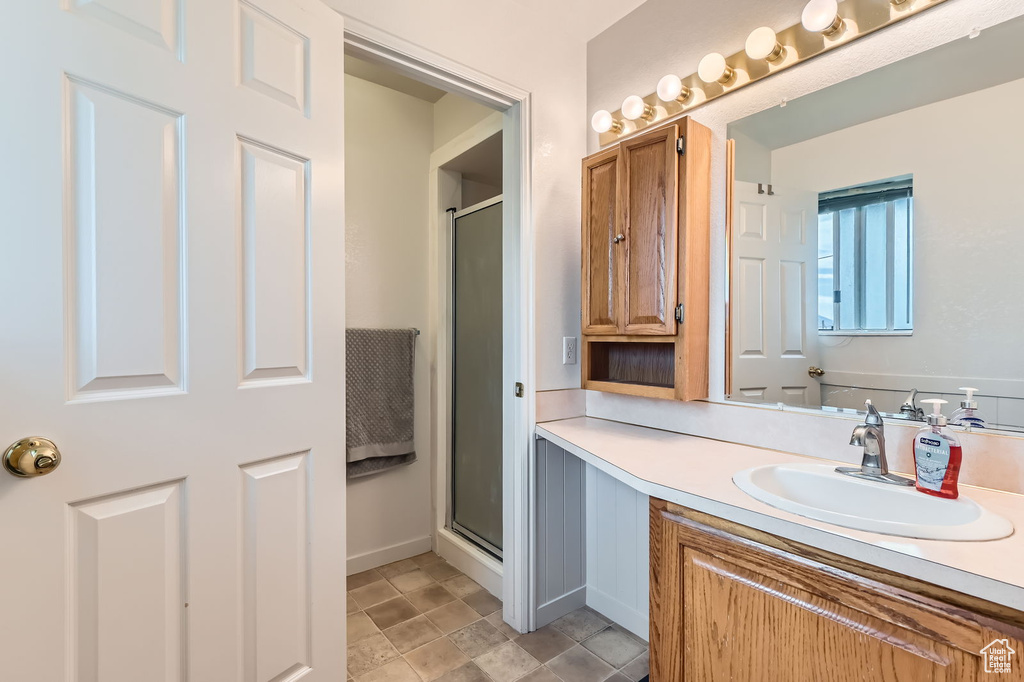 Full bathroom featuring a shower stall and vanity