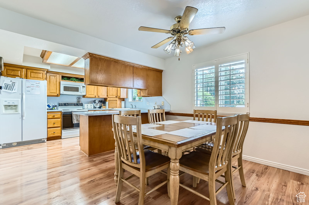 Dining room featuring light wood-style floors and a ceiling fan
