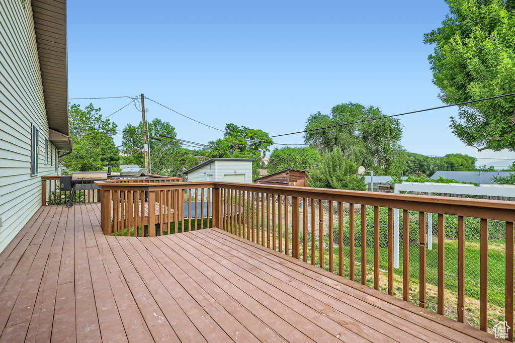 Wooden deck featuring an outdoor structure
