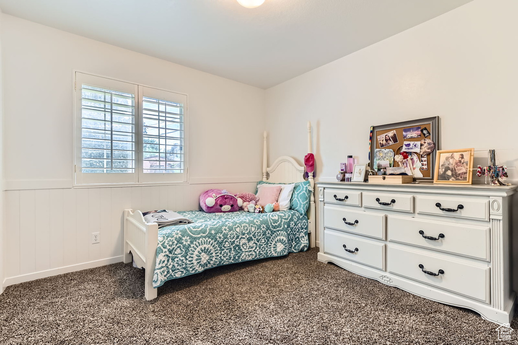 Carpeted bedroom with wainscoting