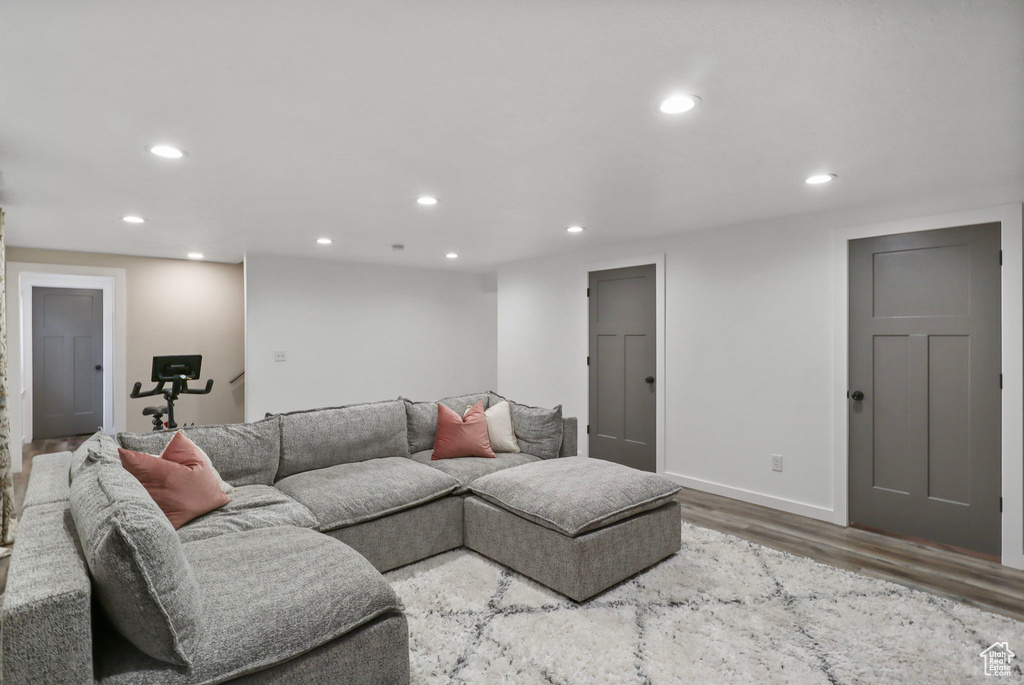 Living room with wood finished floors and recessed lighting