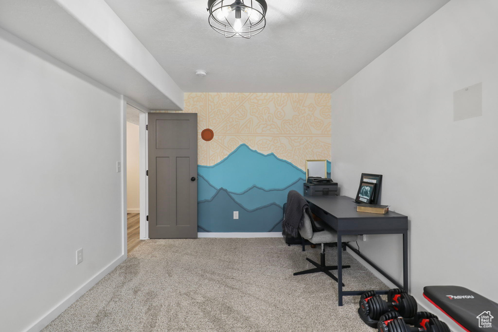 Office area featuring wallpapered walls, an accent wall, and carpet floors