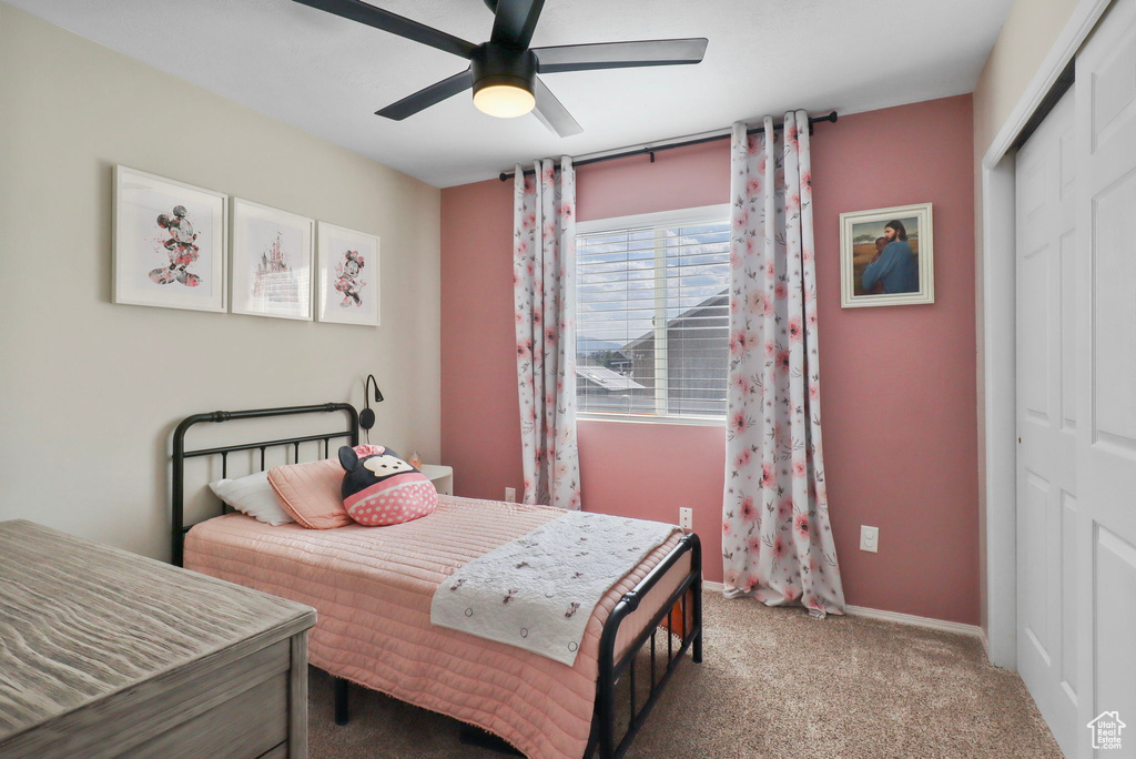 Bedroom featuring a closet, carpet, and ceiling fan