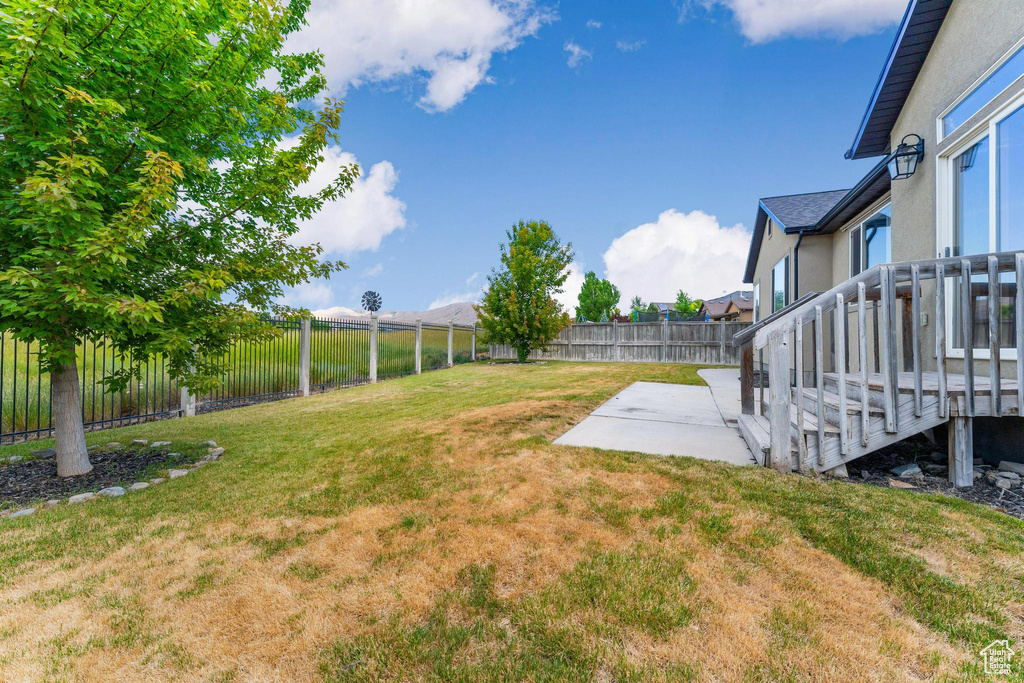 Fenced backyard featuring a patio