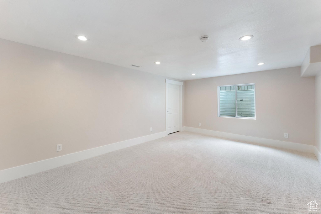 Unfurnished room with recessed lighting and light colored carpet