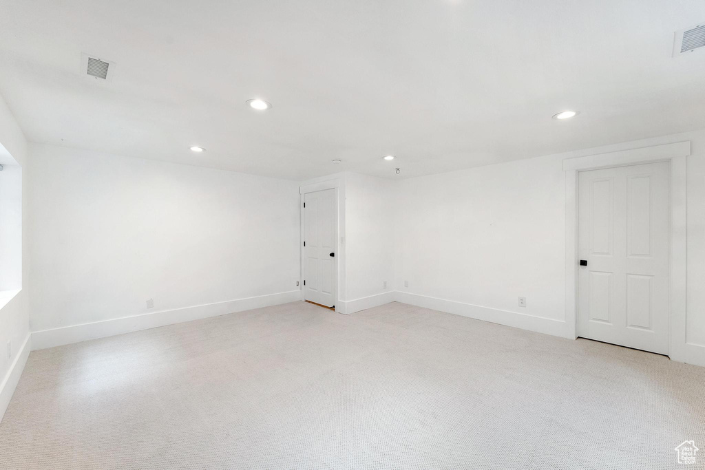 Unfurnished room with recessed lighting and light colored carpet