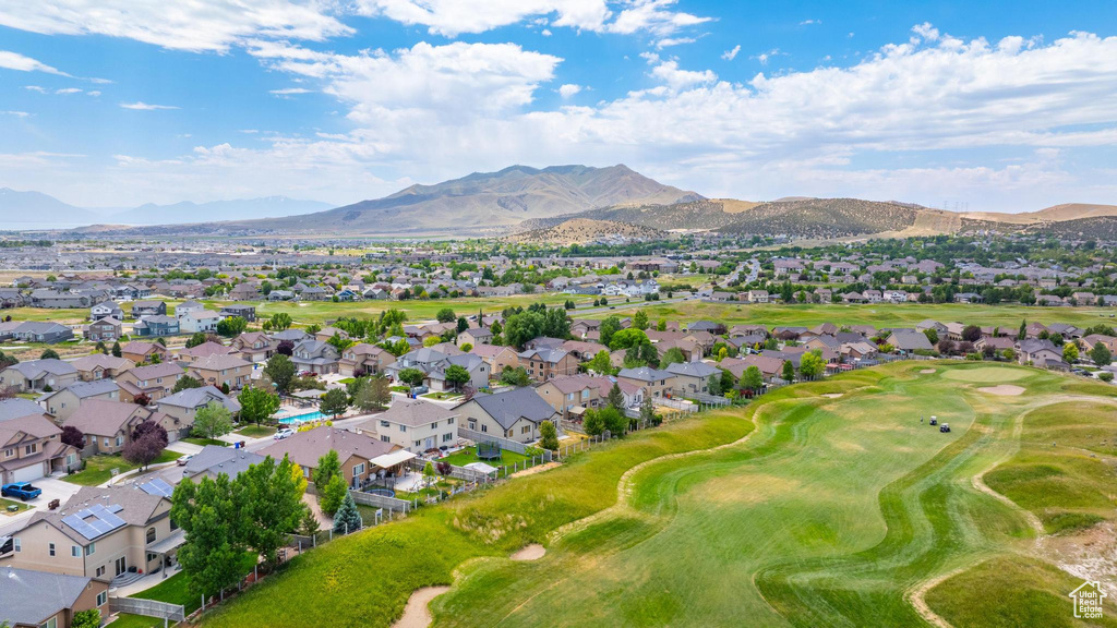 Aerial view of residential area featuring mountains and a golf course