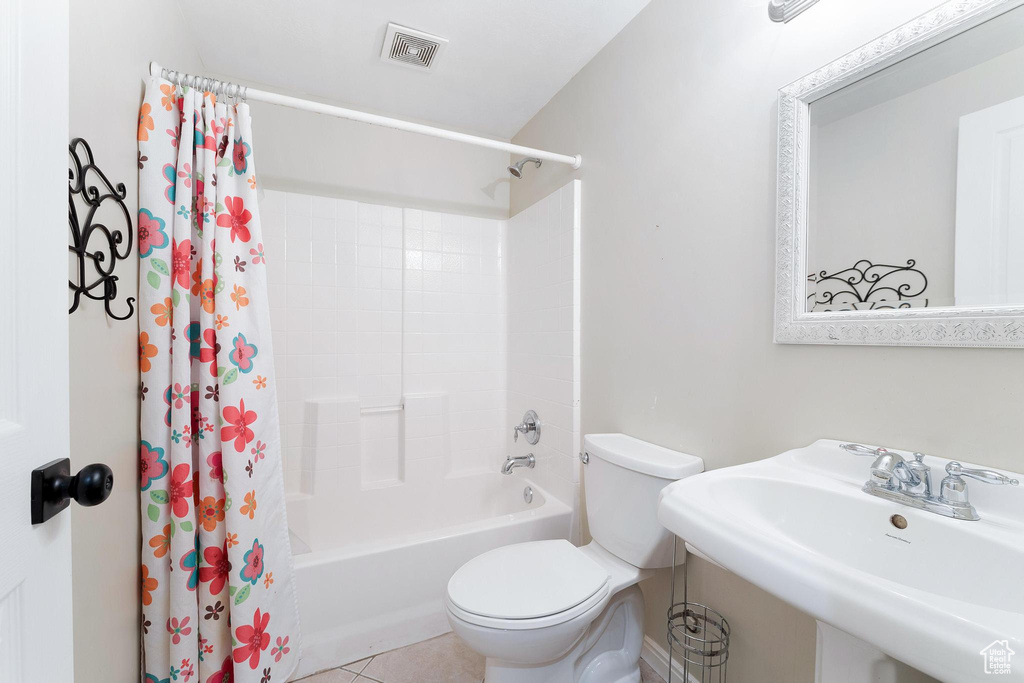 Full bathroom with shower / bathtub combination with curtain and tile patterned floors