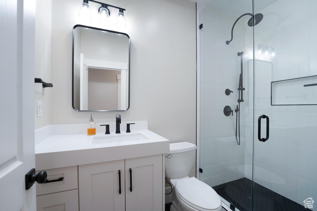 Bathroom featuring a stall shower and vanity