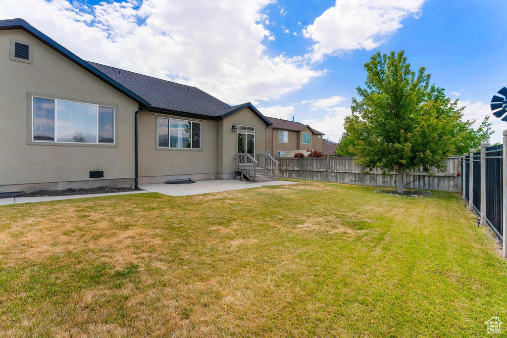 Fenced backyard with a patio
