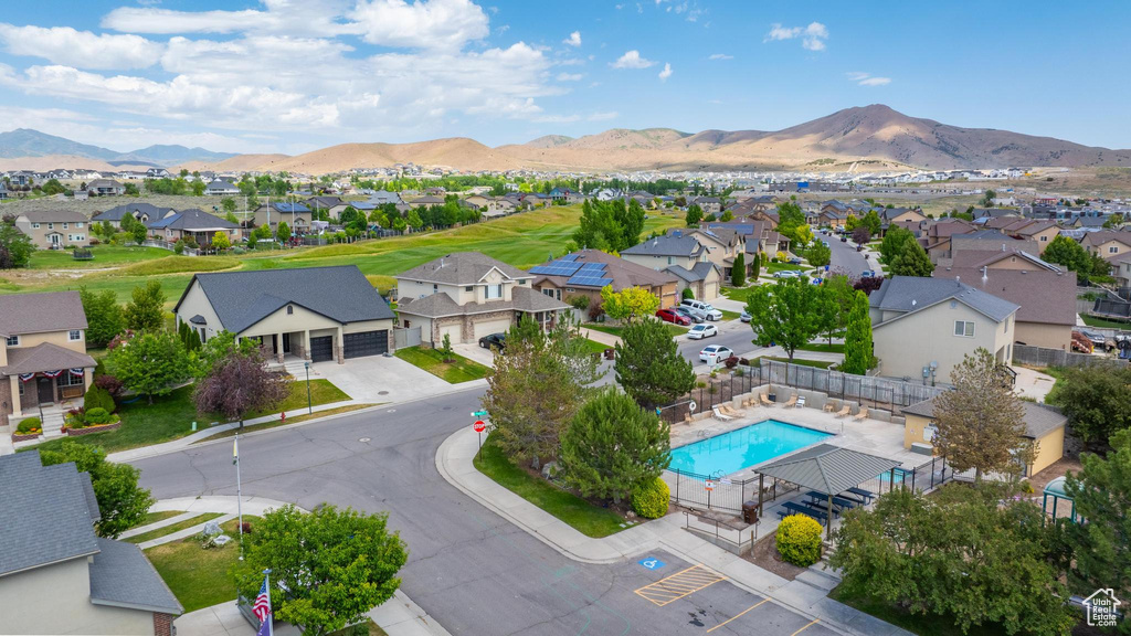 Aerial perspective of suburban area featuring mountains and a pool area