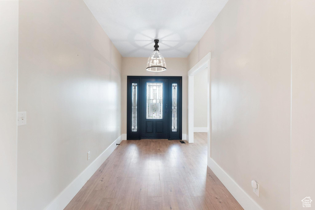 Entryway with wood finished floors and baseboards