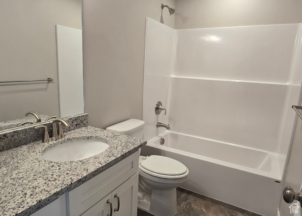 Full bath with vanity, tub / shower combination, and marble look tile flooring