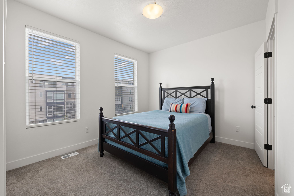 Carpeted bedroom featuring baseboards