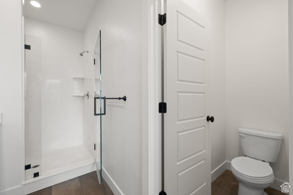 Bathroom with a shower stall and recessed lighting