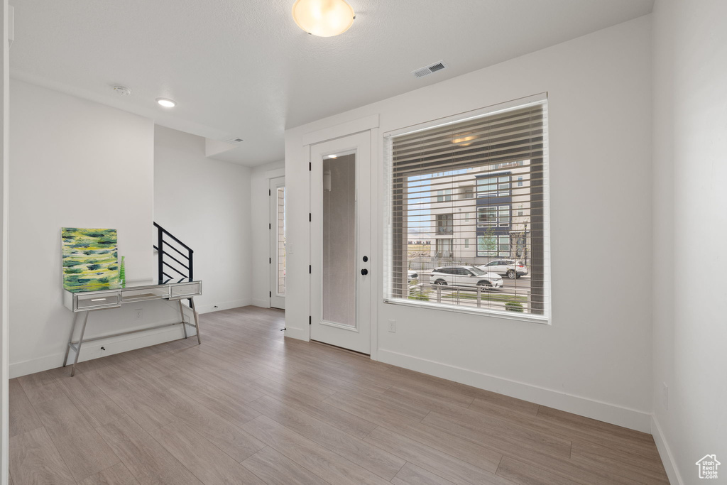 Entryway featuring light wood-style flooring and stairs
