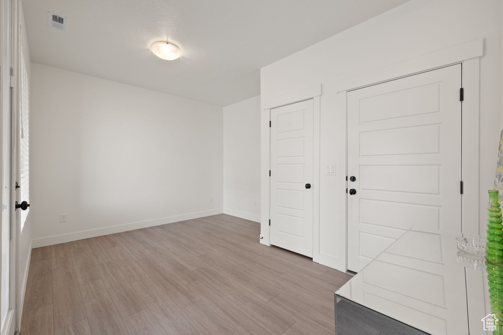 Unfurnished room featuring light wood-type flooring and baseboards