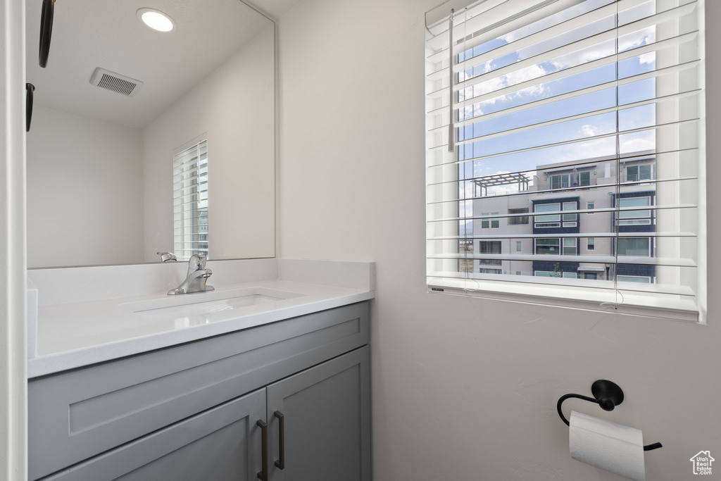 Bathroom with vanity and recessed lighting