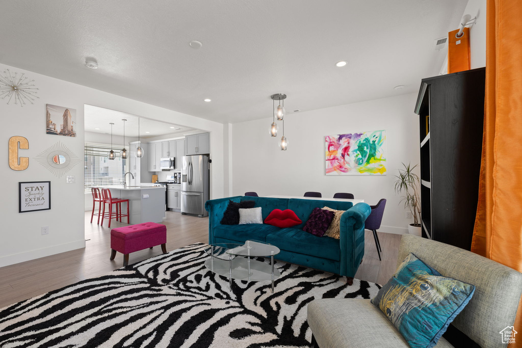 Living room featuring light wood finished floors and recessed lighting