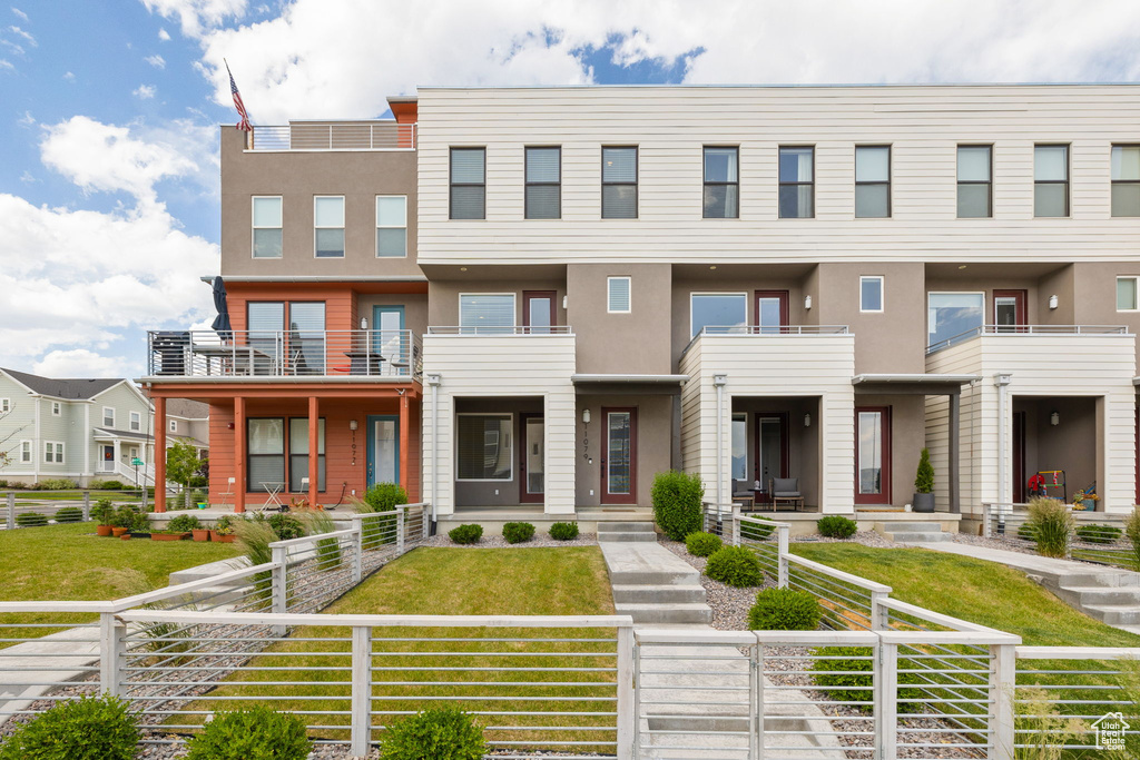 View of property featuring stucco siding and a fenced front yard