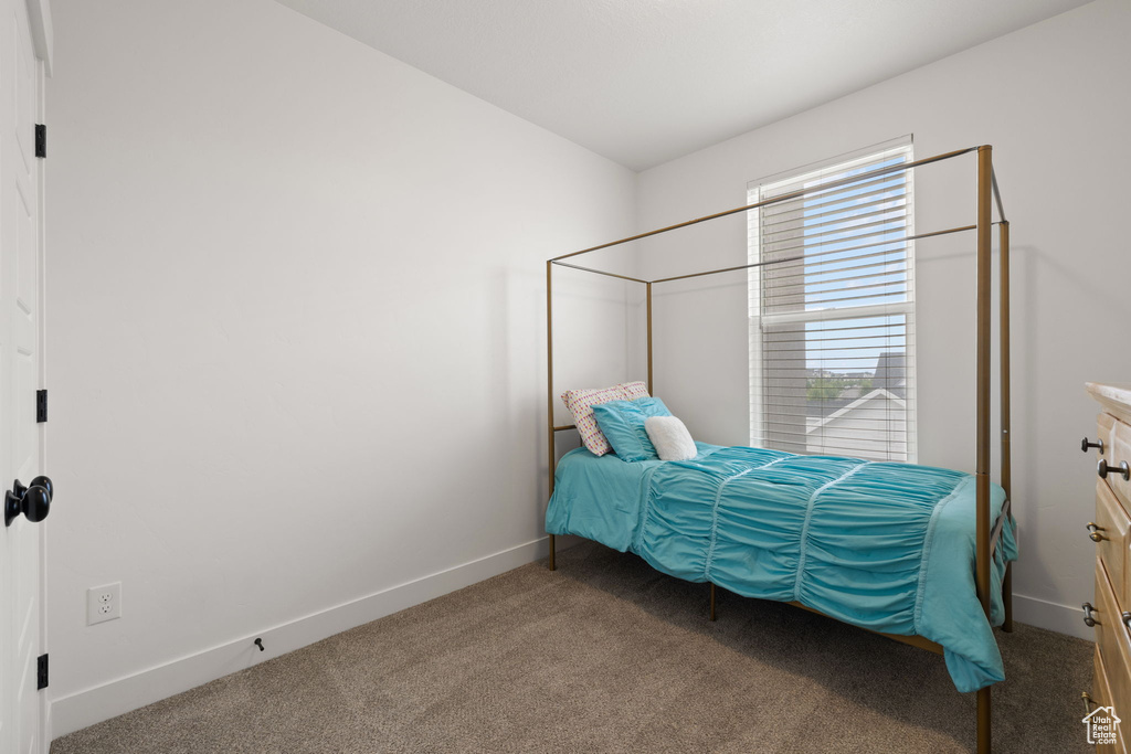 Bedroom featuring carpet flooring and baseboards