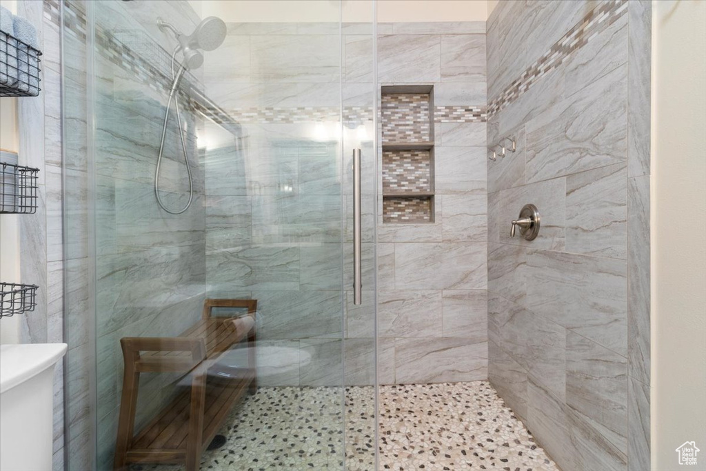 Bathroom featuring toilet and a stall shower