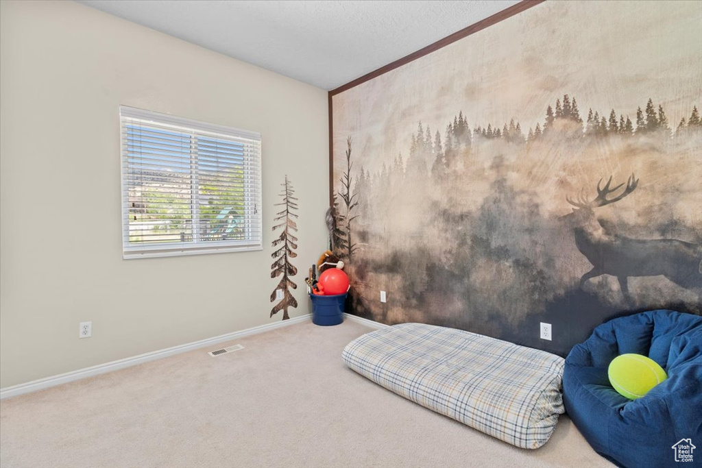 Carpeted bedroom with baseboards and ornamental molding