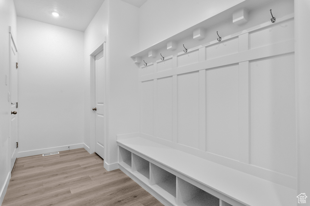 Mudroom with light wood-style floors and recessed lighting