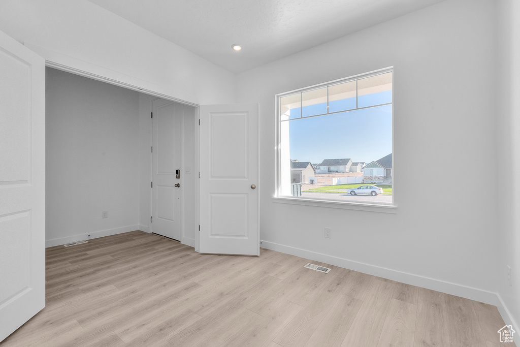 Unfurnished room with light wood finished floors and recessed lighting
