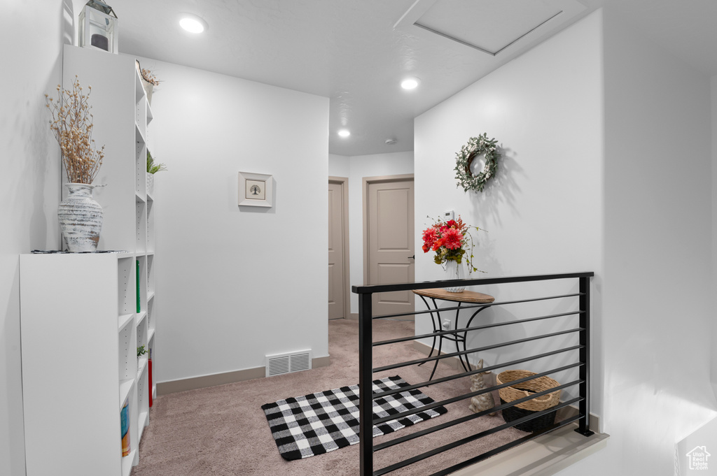 Hall with carpet, an upstairs landing, attic access, and recessed lighting