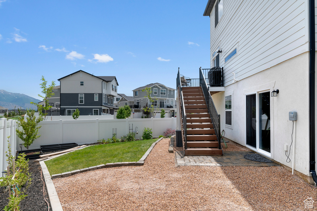 Fenced backyard with stairway and a residential view